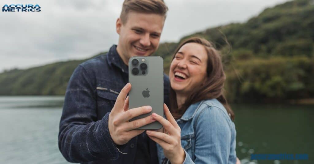 A happy couple enjoying the Apple iPhone 15 Pro Max outdoors, illustrating their joyful interaction and connection through technology.