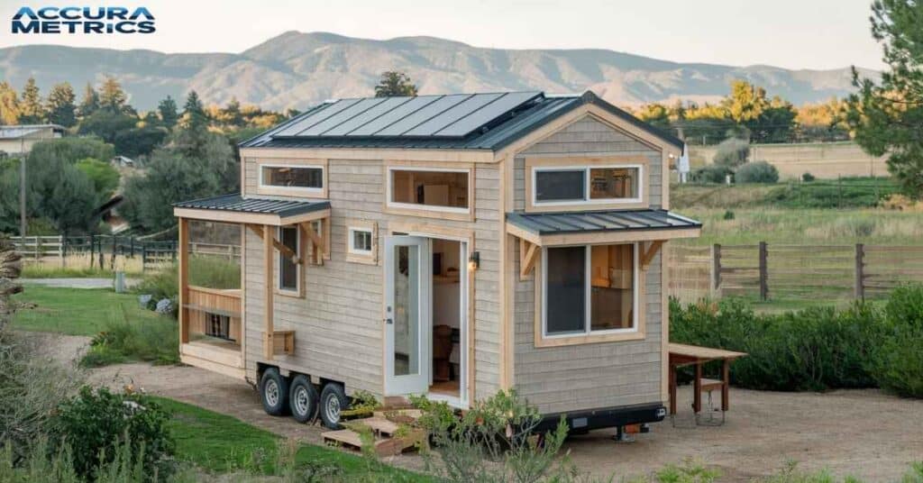 On wheels in a California rural setting with natural wood exterior, solar panels, and surrounded by trees.