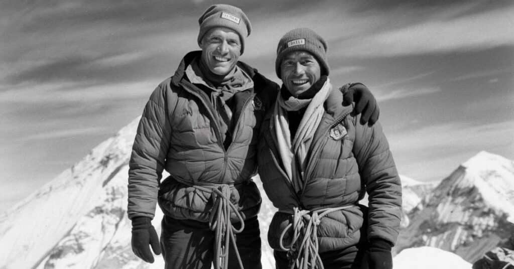 Sir Edmund Hillary and Tenzing Norgay standing at the summit of in 1953, marking the first successful ascent of the world's highest mountain.