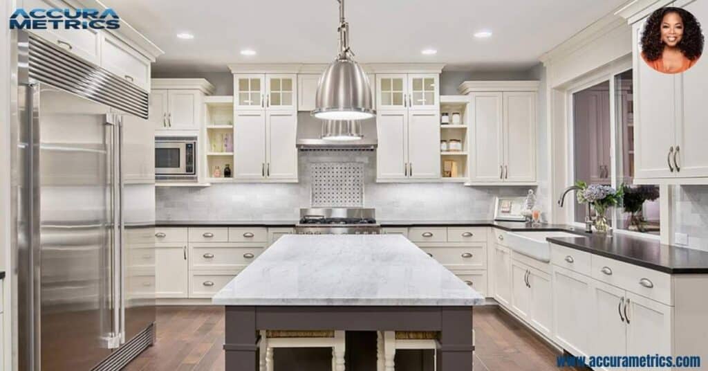 The kitchen in Oprah featuring high end appliances, an expansive marble island.