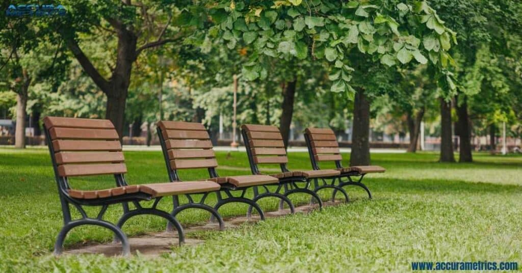 Four park benches lined up to measure twenty feet.