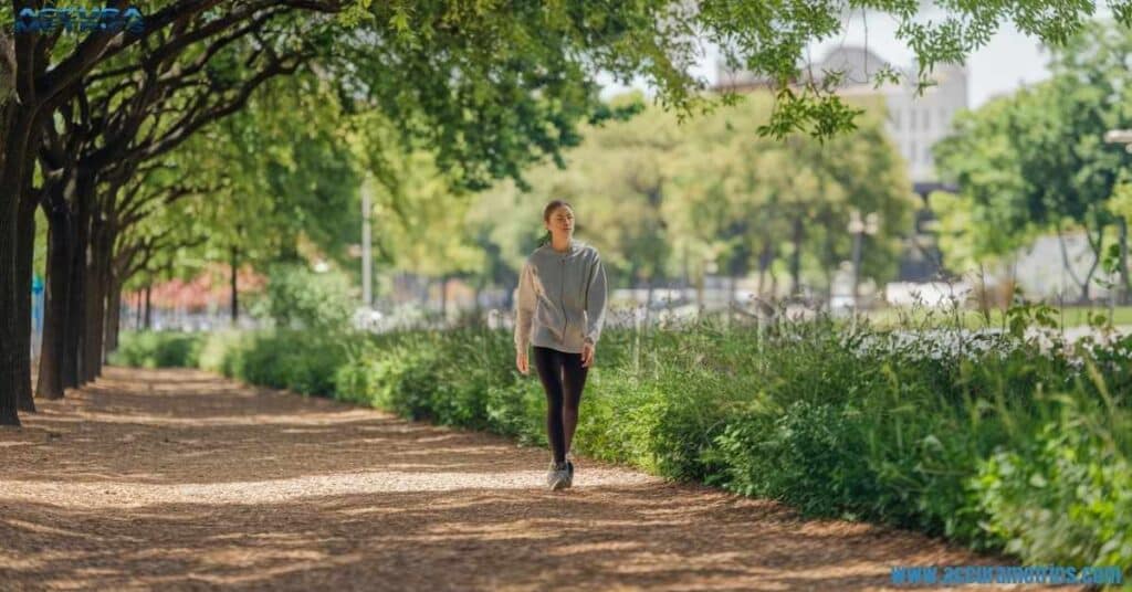 Person walking 10 kilometers in a peaceful park, enjoying nature.